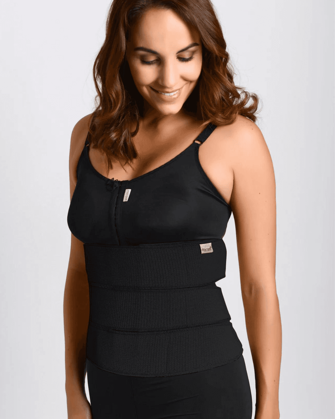 Image of a macom black post-operative 3 Panel Binder for abdominal compression. This abdominal binder is elasticated with velcro fastening provides flexible and adjustable compression. Ideal for post-abdominal surgery recovery including, hernia surgery, bariatric surgery, and as a back support. Enhance your recovery with this comfortable and supportive compression garment